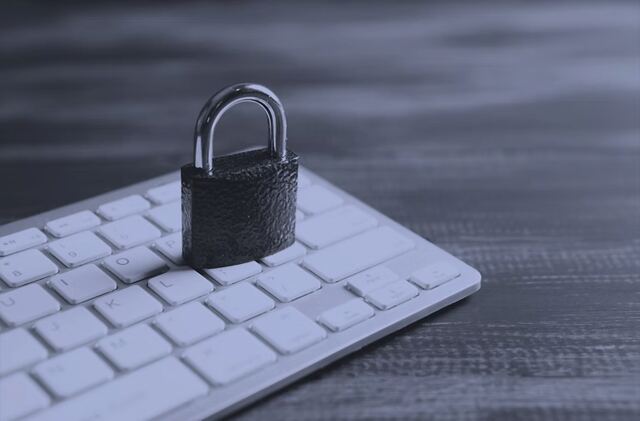 A padlock resting on a keyboard, representing the Information Security Escape Room